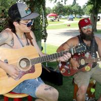 Ethan Ryans (left) and Cody Hassell play their guitars
