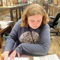 Janie Johnson fills out paperwork during a volunteer shift