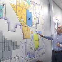 Dave Stewart gestures toward a map