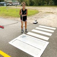 Jessie Garcia paints a crosswalk