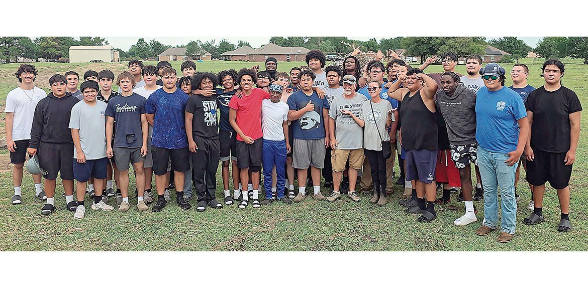 Connie Holt and husband, Bob Ballhorn (front row gray shirts) got help from the EHS football team_slideshow