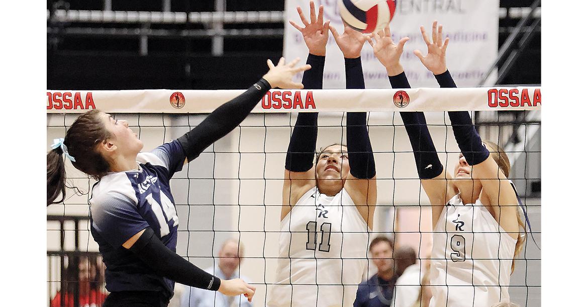 Meredick Martinez (11) and Quinn Charmasson (9) attempt a block on an Altus hitter_slideshow