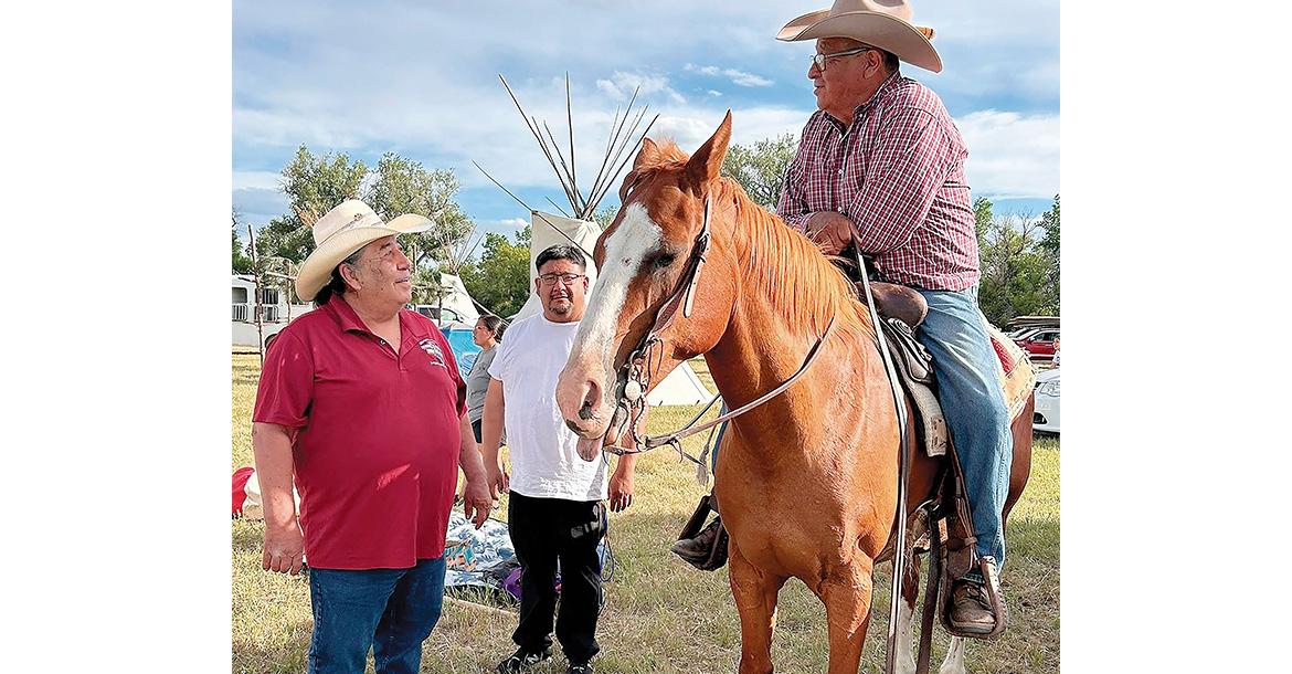 Chester Whiteman (left) visits with members of the Northern tribes_slideshow
