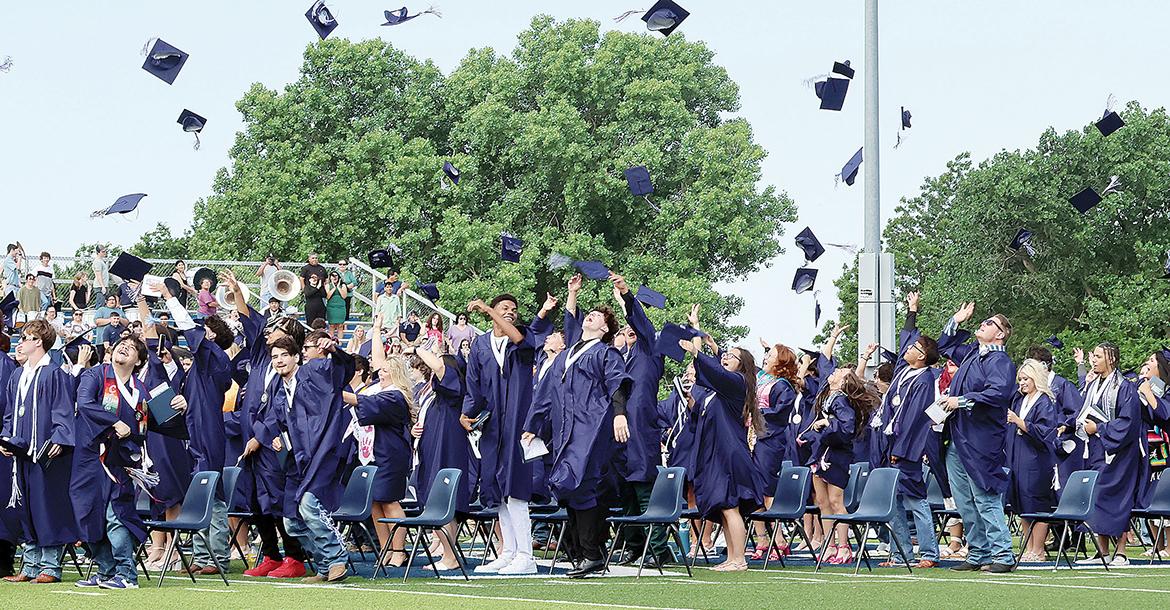 Graduates throw their caps into the air_slideshow