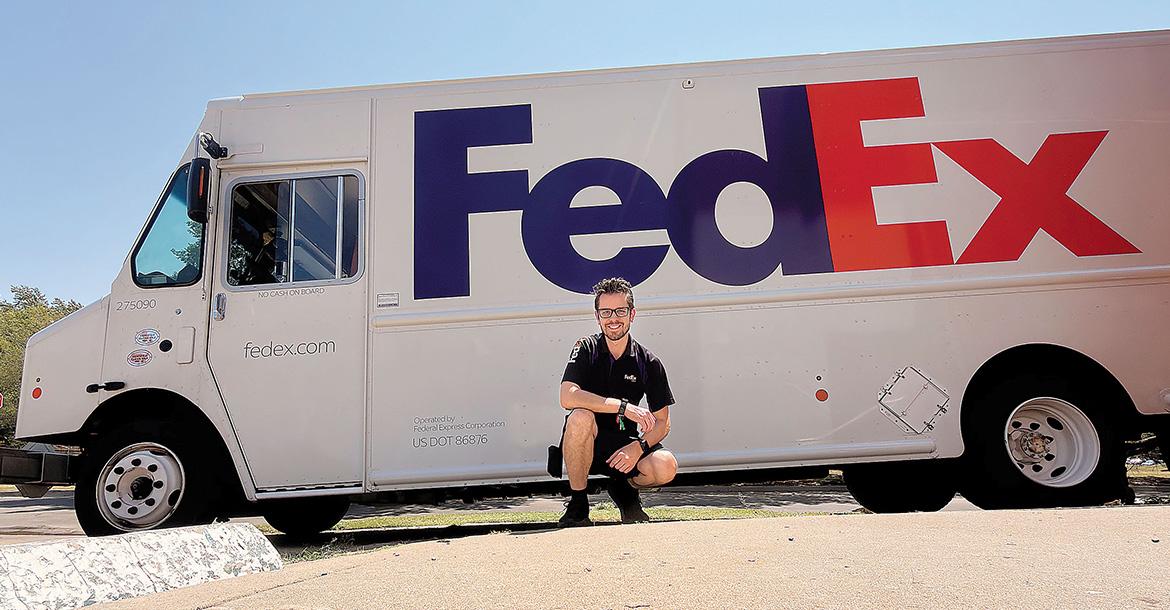 Matthew Snyder posing with his Federal Express truck_slideshow