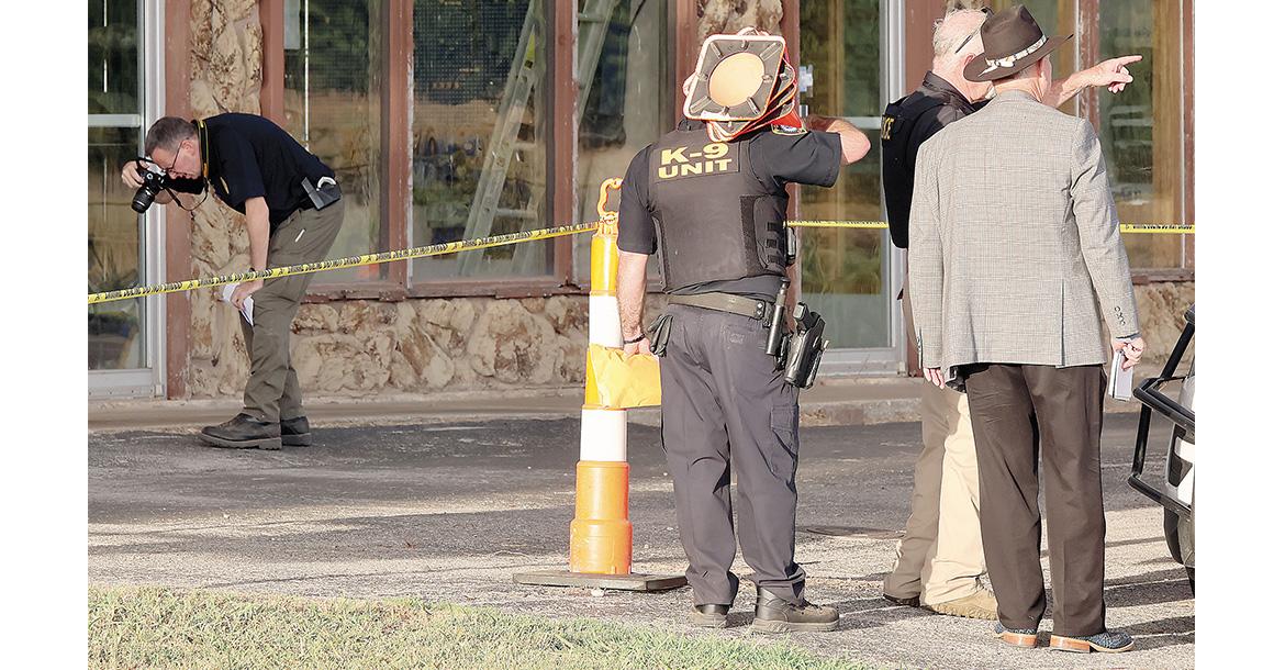 Kirk Dickerson (hat) listens to information being relayed while Capt. David Beaty takes a photo_slideshow