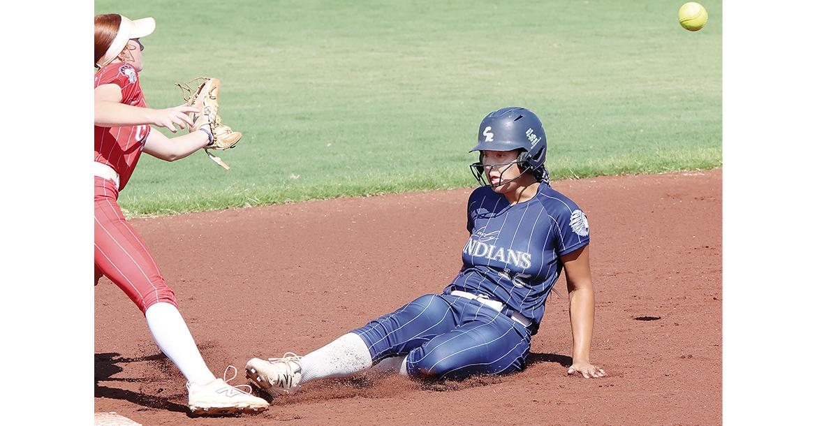 Addilinn Johnson slides into second base ahead of a pickoff throw_slideshow