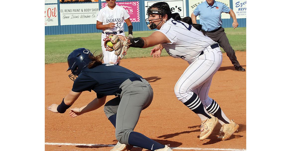 Taylor Acosta reaches out to tag a runner diving into the bag_slideshow