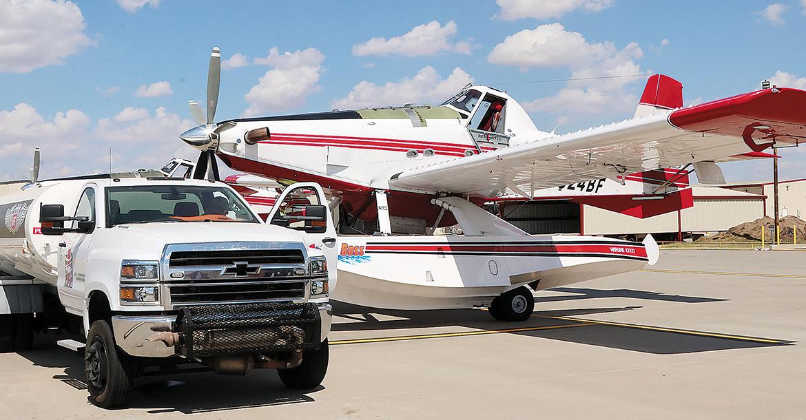 The fuel tanker at El Reno Regional Airport pulls up next to one of the firefighting planes_slideshow