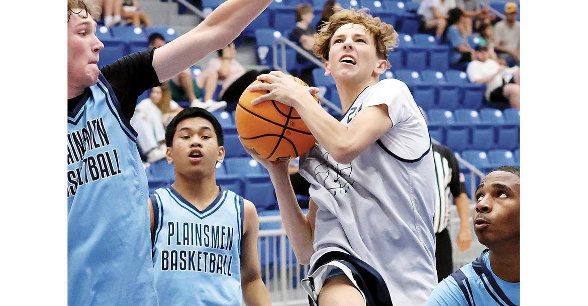 Graham Philips weaves through three Enid defenders_slideshow