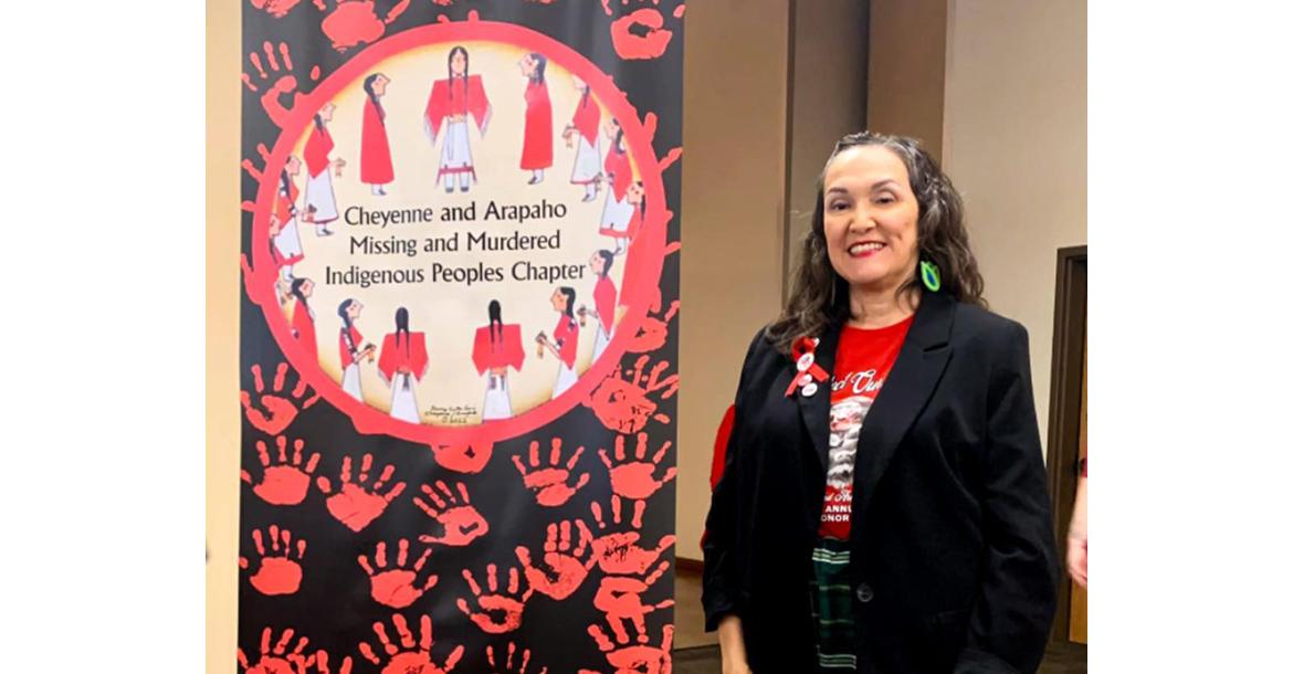 LaRenda Morgan stands next to the Cheyenne and Arapaho sign dedicated to missing persons_slideshow