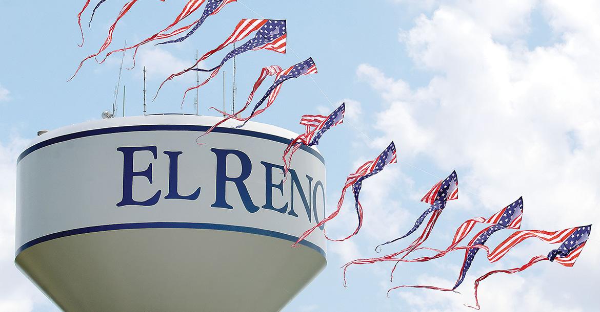 A patriotic kite flies in front of the water tower_slideshow