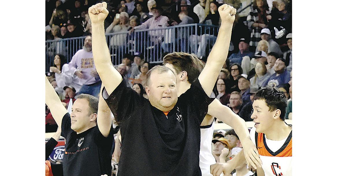 Jacob Mayfield throws his hands up in the air after Calumet won the first of two back-to-back state championships_slideshow
