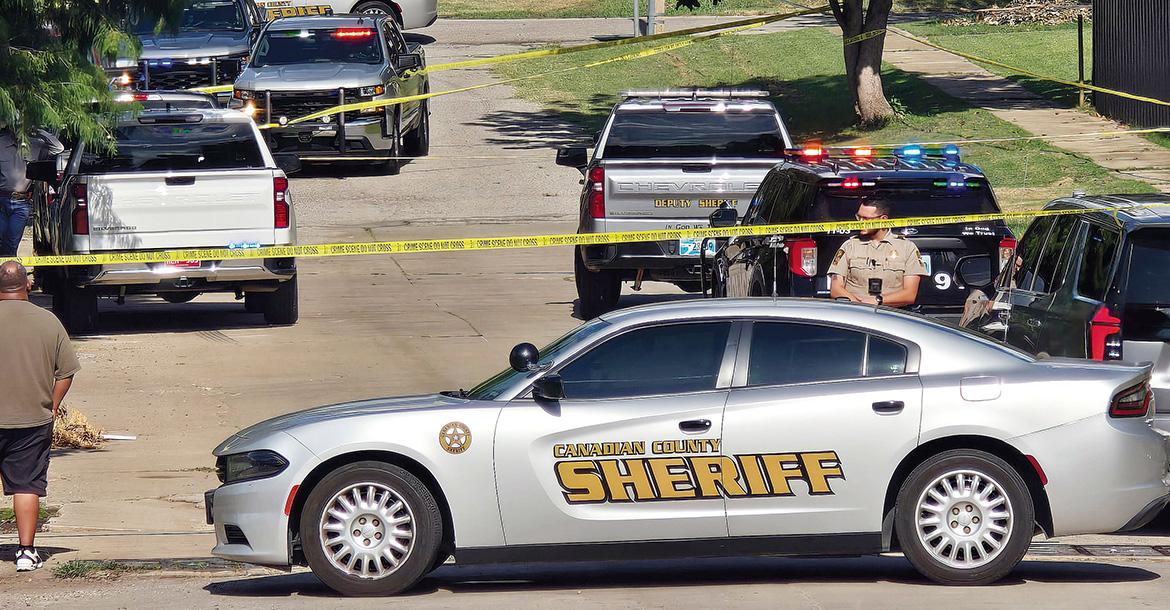 Vehicles from the Canadian County Sheriff’s Office and El Reno police surround a home_slideshow