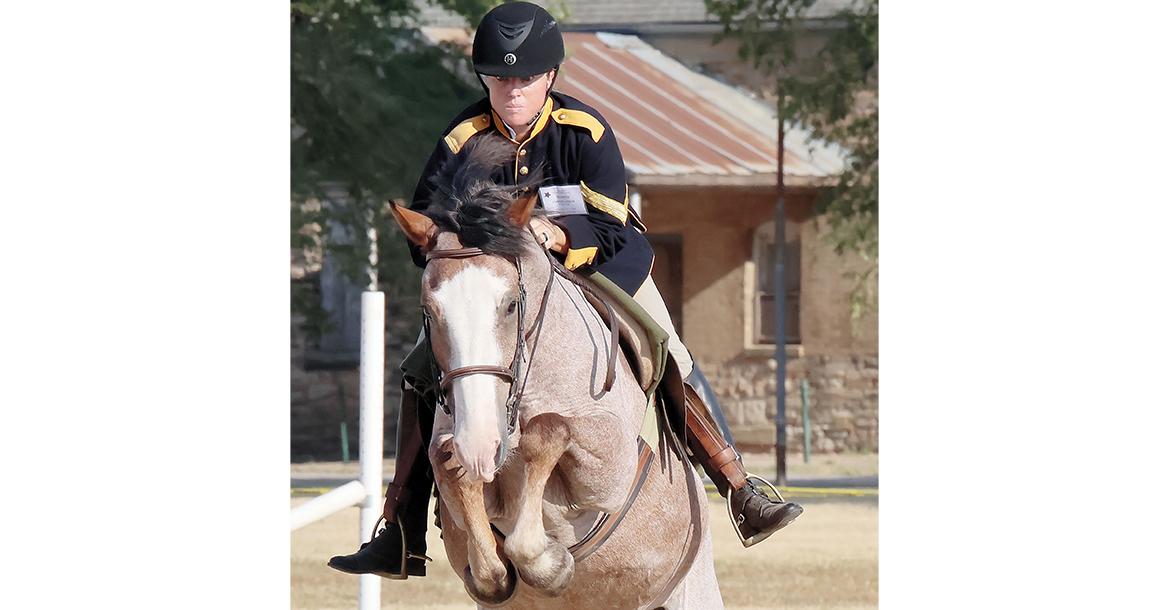 Christa Smith jumps Rooster over a pole_slideshow
