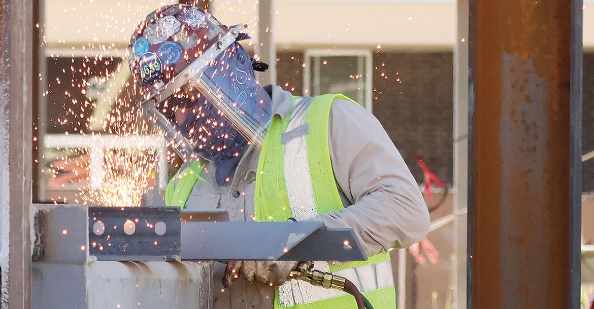 Sparks fly in all directions as a welder works on a steel structure_slideshow