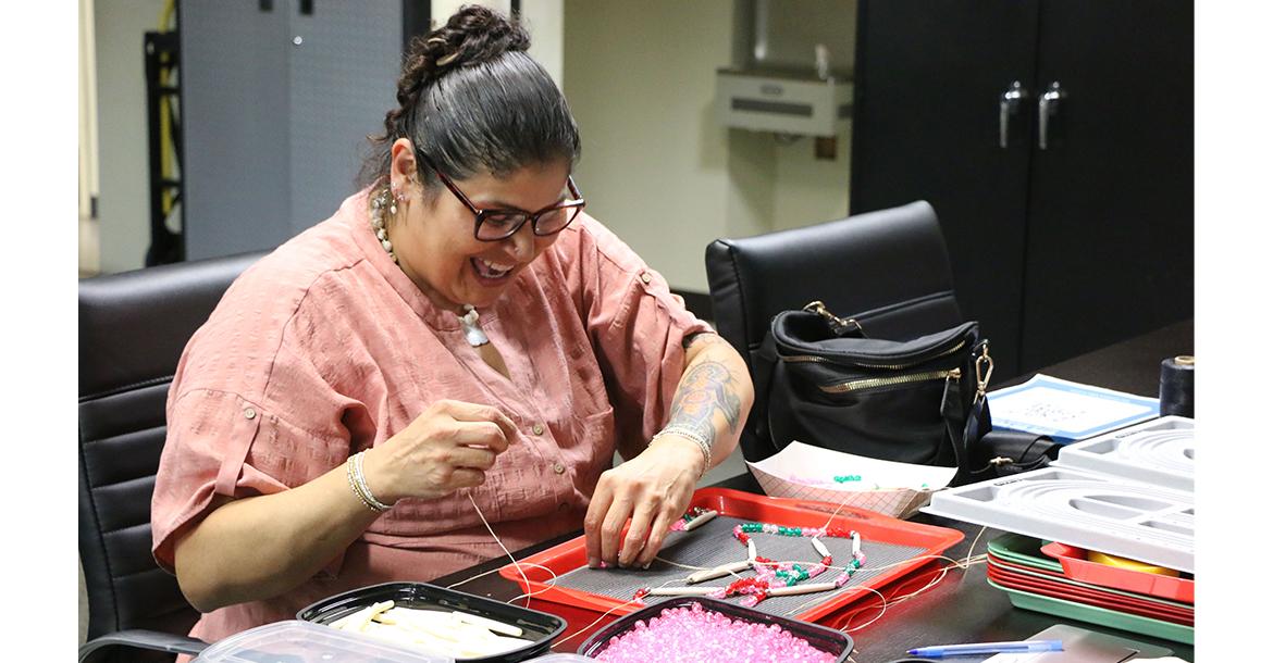 Kathryn Toahty enjoys beading necklaces during the event_slideshow