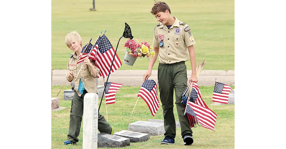 Riley Griesel-Garrison and Paxton Edens search for veterans graves_slideshow