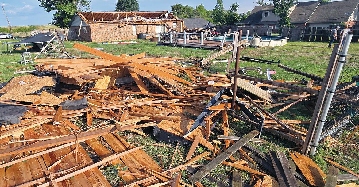Mike Murray (back right) talks with Bobby Don Stevenson, who had stopped by to check the damage to Murray’s home_slideshow