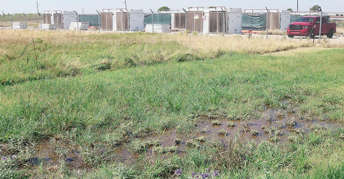 A large pool of water and green grass can be seen to the east of the Jensen Road property_slideshow