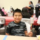 Christian Shorteeth, 10, makes a gourd