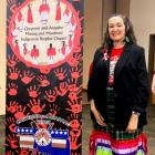 LaRenda Morgan stands next to the Cheyenne and Arapaho sign dedicated to missing persons