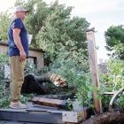 Darren Koehn stands on top of his pool deck looking over the damage to his property