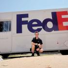 Matthew Snyder posing with his Federal Express truck