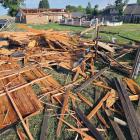 Mike Murray (back right) talks with Bobby Don Stevenson, who had stopped by to check the damage to Murray’s home