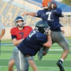 Nathan Ashmore (7) throws a pass around a defender getting blocked along the line of scrimmage