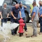 Jason Duff watches a spray of water shoot out of a hydrant along Jensen Road