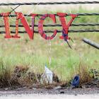 A memorial for El Reno’s Quincy Jones is hung from the cable barrier near the crash site