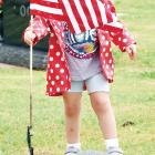 Colette Burns puts a flag on the grave of a veteran