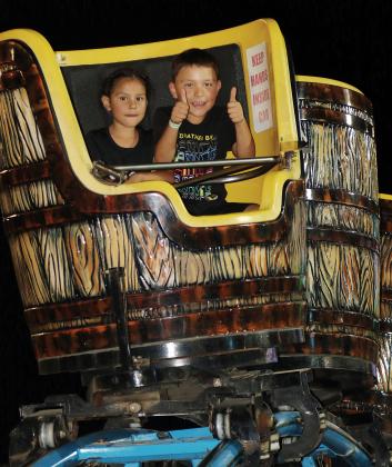 Children gave a thumbs up to one of the carnival rides