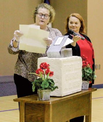 Dr. Kristy Ehlers opens the time capsule with Amy Neathery 