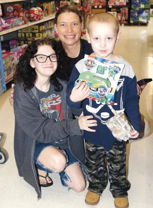 Liz Hodgson poses with her little shoppers, Jessica Parson (left) and Lyric Kaup
