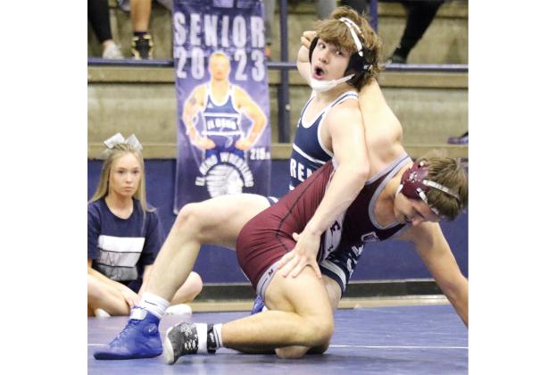 El Reno High School wrestler Brandon Harrison reacts to hooking the arm of his Perry opponent on a takedown move. 