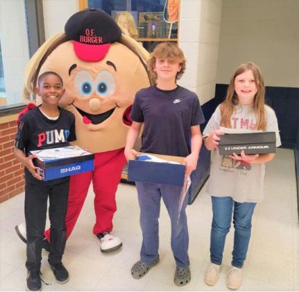 Three of the Bun Run essay winners with their prizes presented by O.F. Burger