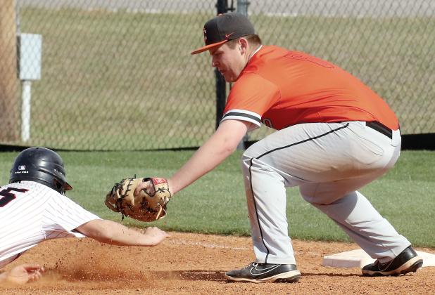 Carson Cooper reaches out to tag a base runner during a pickoff play