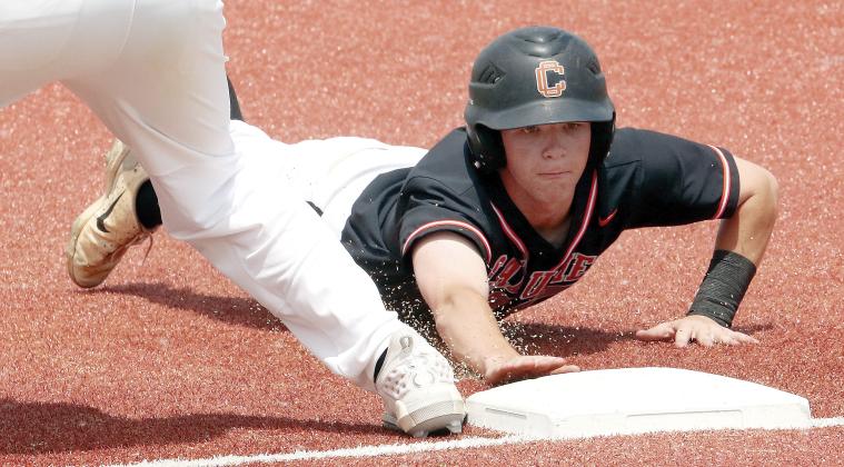 Kingston Arnold dives back into first base ahead of a pickoff throw