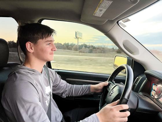 Mason Fulton practices his driving with a parent