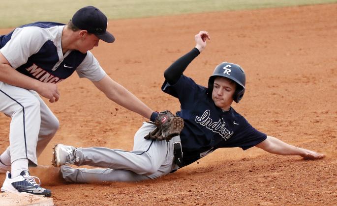 Landon Callow tries to slide under a tag