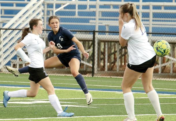 Conley Knapp leaps into the air as she follows through on a shot on goal