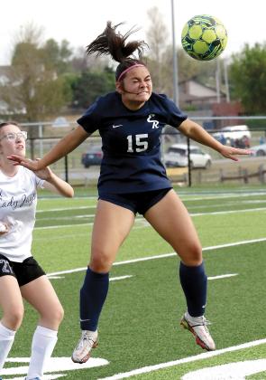Lily Menjivar uses her head to redirect a throw-in pass