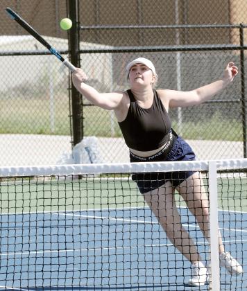 Melanna Idell jumps to reach a forehand return at the net