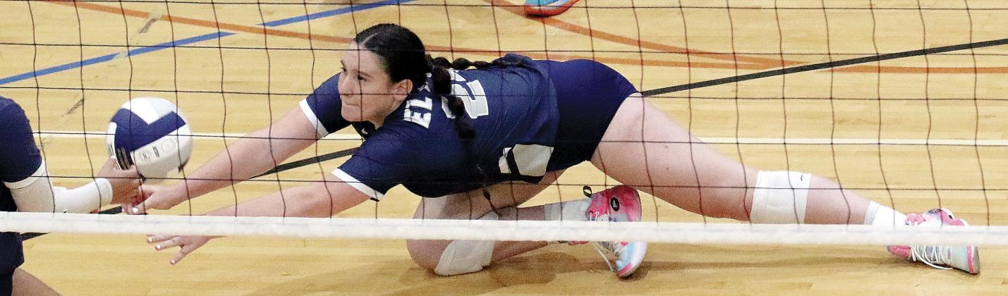 Jewell Graham dives to the floor as she tries to dig up a short ball by the net