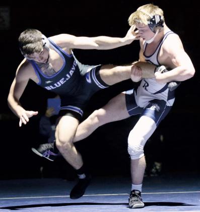 Will Heger, right, sweeps at the back leg of Guthrie’s Braden Hall
