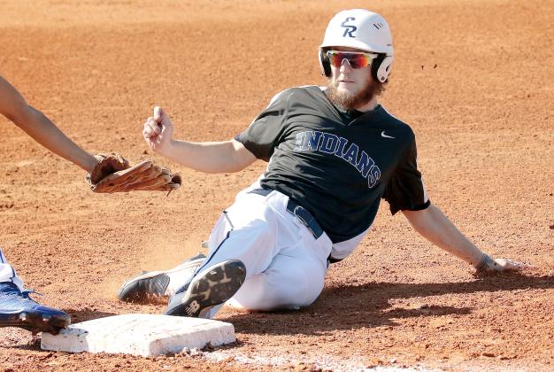 Kolt Glenn slides into third base under the tag from a Southeast player