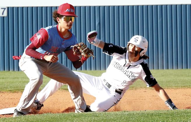 Dacien Ramos slides into second base ahead of a throw to the bag
