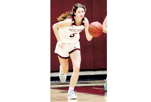 Redlands guard Macy Moore dribbes up the court. 